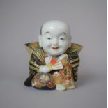 A 20th Century Satsuma ware Figure of Seated Robed Dignitary, with Multi-coloured Applied Enamels,