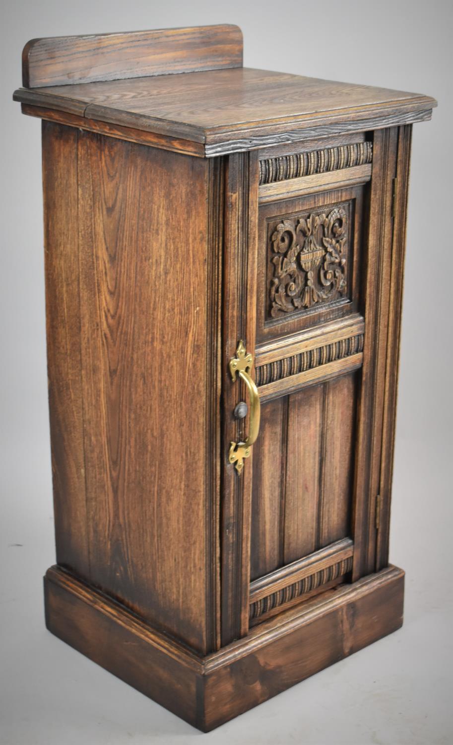 A Mid 20th Century Oak Galleried Bedside Cabinet with Carved and Panelled Door and Brass Handle,