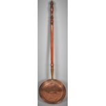 A Copper Bed Warming Pan with Turned Wooden Handles