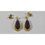 A Pair of Teardrop Shaped Yellow Metal and Red stone Earrings