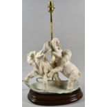 A Reproduction Resin Table Lamp in the Form of Two Elephants Fighting, 49.5cm high