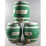 A Set of Three Green, White and Gilt Glazed Ceramic Spirit Barrels for Gin, Brandy and Rum, Each