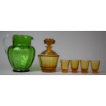 An Amber Glass Decanter and Tot Set Together with a Green Glass Jug