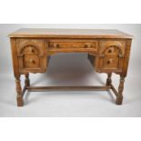A Mid 20th Century Oak Knee Hole Writing Desk with Centre Long Drawer Flanked by Two Short Drawers