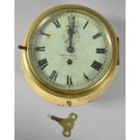 An Early 20th Century Circular Brass Cased Bulkhead Clock, the dial signed "Frank Moore,
