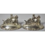 A Pair of Silver Plated Place Card Holders in the Form of Reclining Cherub Drinking From Horns, Each