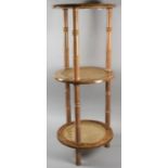 A Faux Bamboo Three Tier Circular Stand with Caned Shelves, 29cm wide