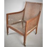 A Late 19th Century Mahogany Framed Bergere Armchair, Requiring Recaning