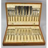 An Edwardian Cased Canteen of Twelve Silver Banded Fish Knives and Forks, All with Bone Handles