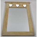 A Modern Wooden Framed Wall Mirror with Hanging Heart Decoration, 39cm high