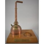 A Modern Glenmorangie Novelty Bottle Stand in the Form of a Copper Still on Wooden Plinth, 31cm high