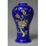 A Crown Devon Blue Glazed Vase with Floral Decoration, 21cm high