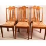 A Set of Six Arts and Crafts Oak Framed Dining Chairs with Inlaid Circular Disks in the Form of