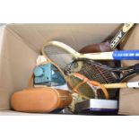 A Box Containing Leather Bottle Case, Metal Tin, Various Rackets etc
