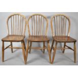 A Set of Three Hooped and Spindled Backed Elm Seated Kitchen Chairs