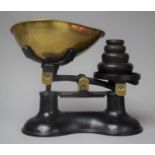 A Set of Brass Mounted Cast Iron Kitchen Scales and Weights