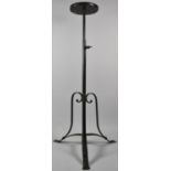 A Modern Wrought Iron Adjustable Tripod Plant Stand