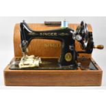A Vintage Oak Cased Manual Singer Sewing Machine
