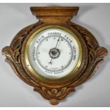An Edwardian Carved Oak Wall Hanging Aneroid Barometer with Brass Bezel, 28.5cm wide