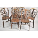 A Set of Six Wheel Backed Elm Seated Kitchen Chairs
