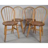 A Set of Four Circular Seated Spindle Back Kitchen Chairs