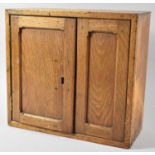 A Wall Hanging Oak Cabinet with Panelled Door, 35.5cm Wide
