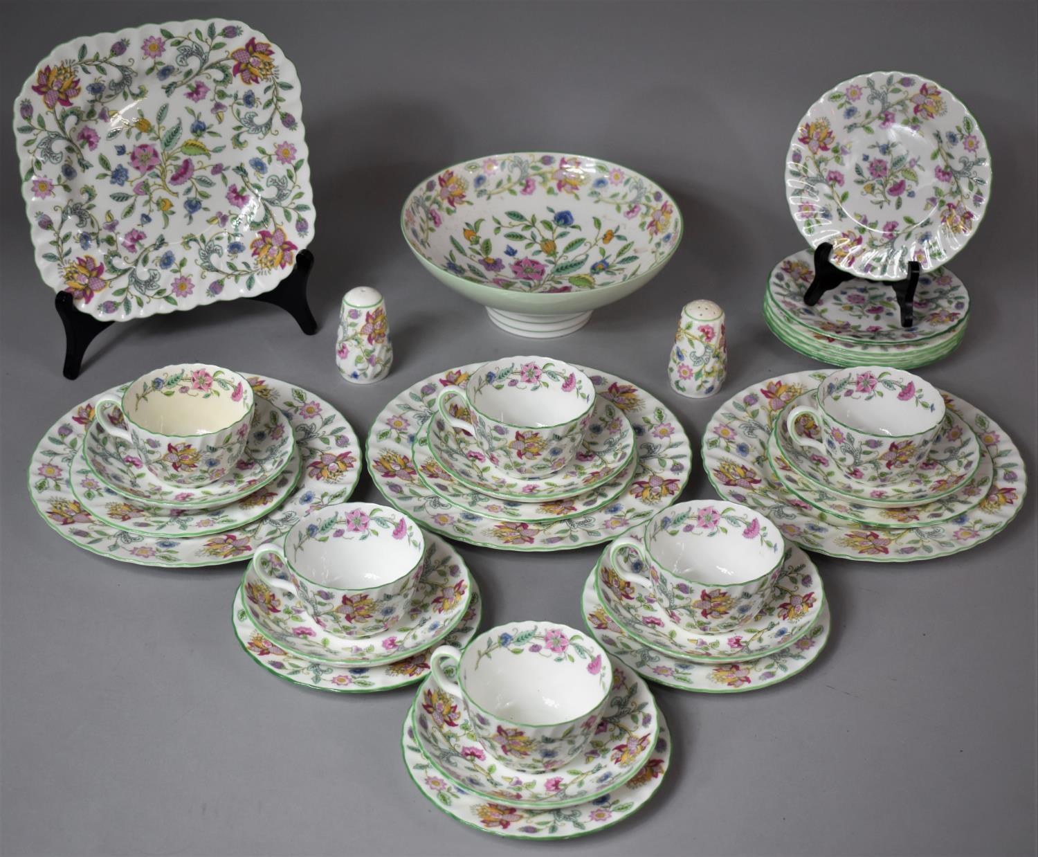 A Collection of Minton Haddon Hall Tea and Dinnerwares to Include Six Trios, Salt and Pepper Pots,