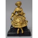 A French Gilt Figural Clock Finial in the Form of a Seated Maiden with Posy of Flowers, Set on an