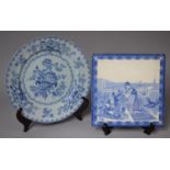 A French Blue and White Faience Wall Tile with Transfer Printed Scene, 21cm Square Together with a