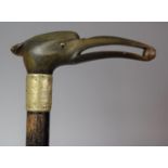 An Ebonised Walking Cane with Carved and Moulded Horn Handle in the Form of a Bird with Pea in Beak,