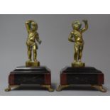 A Pair of French Bronze and Marble Clock Garnitures in the Form of Cherubs Which Would Formerly Have