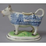 A 19th Century Transfer Printed Blue and White Cow Creamer with Green Painted Base Having Moulded