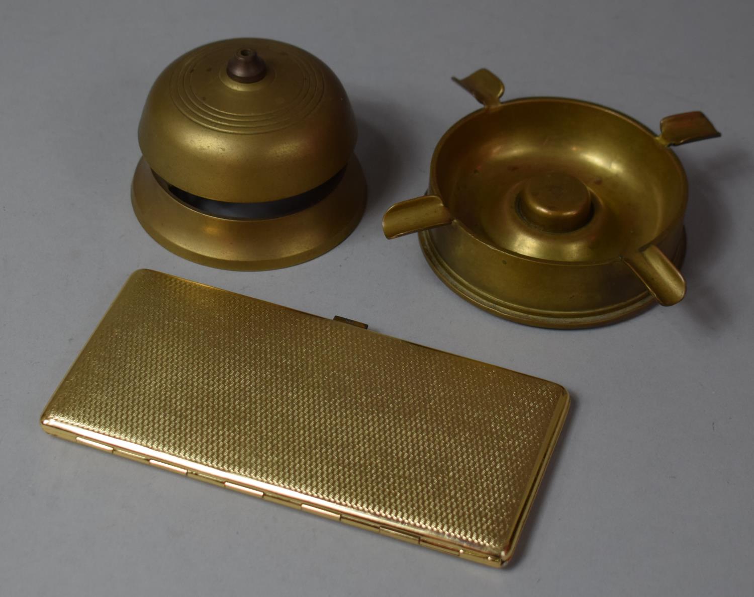 A Collection of Brassware to Include Trench Art Style Ashtray, Reception Bell (AF) and a Cigarette