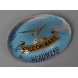 A Early 20th Century Glass Advertising Paperweight for "Falcon Make Headwear", 9cm wide