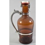 A Modern Amber Glass 2lt Cask Flask with Dolphin Handle, 33cm High