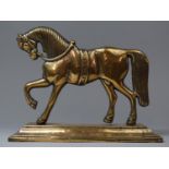 A 19th Century Brass Fireside Ornament or Doorstop in the Form of a Warhorse on Stepped