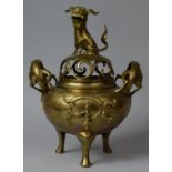 A Cast and Pierced Bronze Chinese Censer with Foo Dog Final and Dragon Stylised Handles Set on