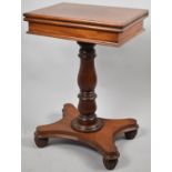A Victorian Mahogany Twist Top Games Table on Turned Vase Support with Quadrant Base and Four Carved