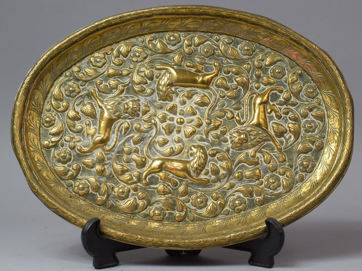 An Indian Brass Oval Wall Hanging Decorated in Relief with Four Lions, 28cm Long