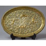 An Indian Brass Oval Wall Hanging Decorated in Relief with Four Lions, 28cm Long