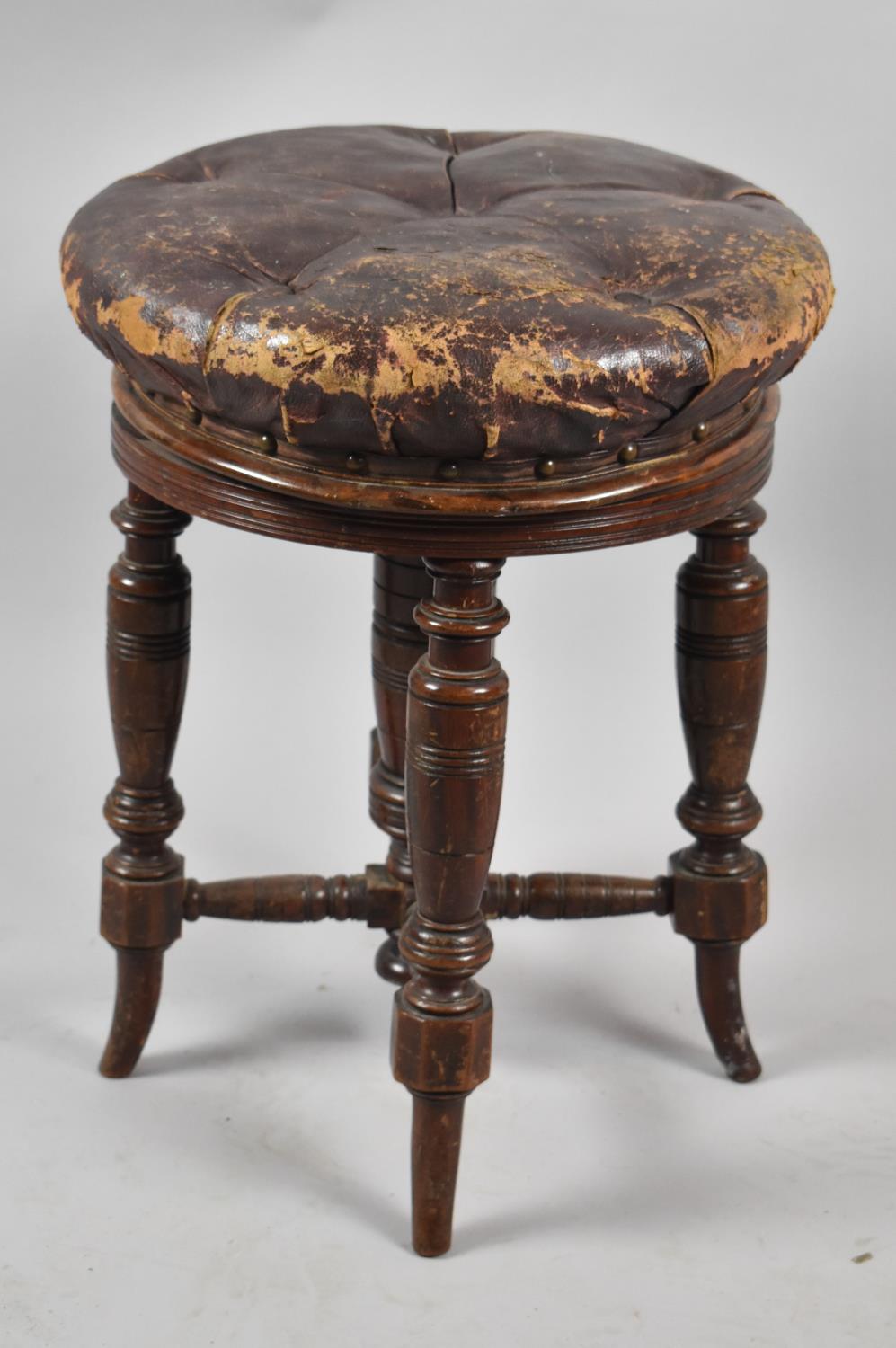 A Late Victorian Circular Topped Revolving Piano Stool on Turned Supports and with Buttoned