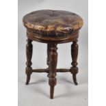 A Late Victorian Circular Topped Revolving Piano Stool on Turned Supports and with Buttoned