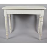 An Edwardian White Painted Rectangular Occasional Table with Turned Supports, 93cm wide