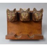 A Black Forest Novelty Wall Hanging Pipe Rack Decorated with Three Cat Heads, Each with Glass