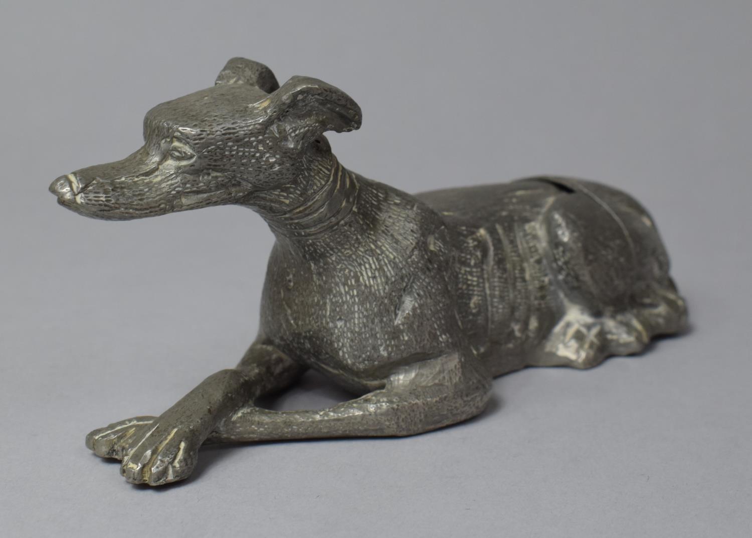 A Mid 20th Century Novelty Continental Aluminum Spill Holder in the Form of a Reclining Greyhound