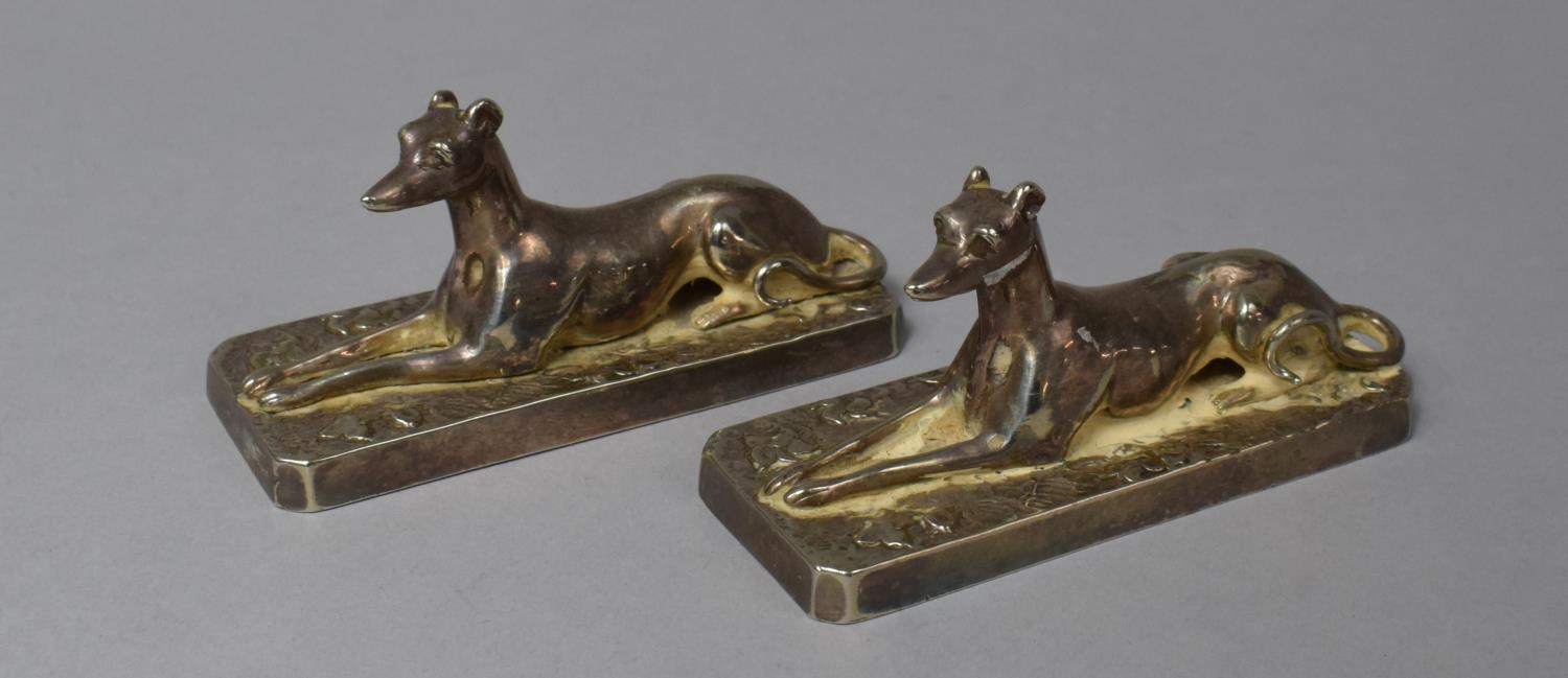 A Pair of Silver Plated Mounts in the Form of Reclining Greyhounds on Rectangular Bases, Each 9cm