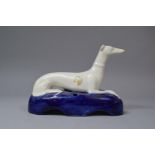 An Early 20th Century Staffordshire Penholder in the Form of a Reclining White Greyhound on Cobalt