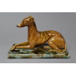 A Mintons Majolica Study of a Reclining Greyhound, 18.5cm High