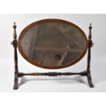 An Edwardian Mahogany Oval Swing Dressing Table Mirror, 44cm wide, Stretcher Has Been Glued