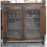 An Oak Lead Glazed Two Shelf Bookcase with Carved Top Rail, 94cm wide